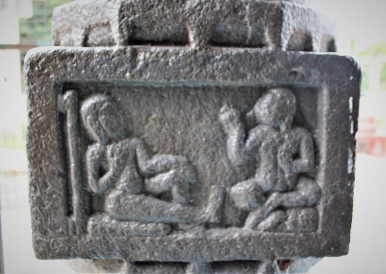 Pillar No. 4: A Nātha-Yogī with one leg spread and a staff seated with another yogi is shown to the west.