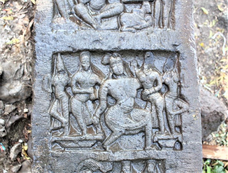 The middle compartment shows the vīra being carried by two nymphs.