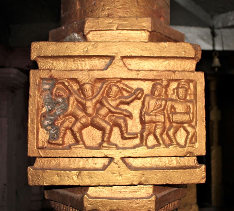 A sculpture of three men with four legs.