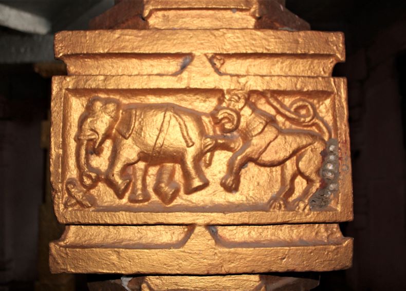 A scene of a lion attacking an elephant.