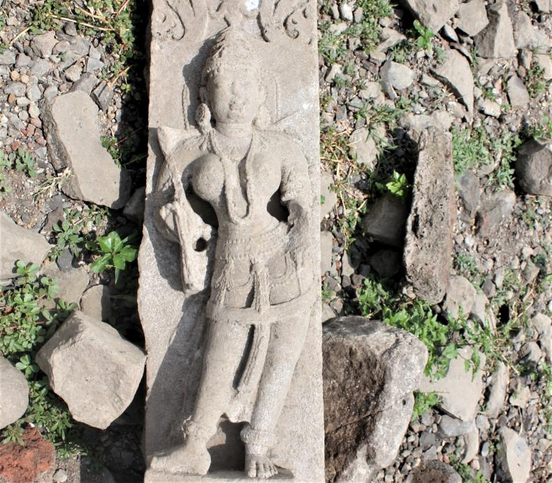 Isolated sculpture of (Rati?) laying down on the northern side of the temple.